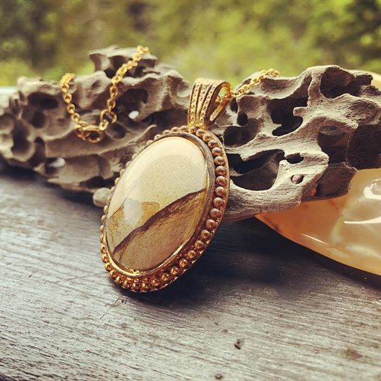 Necklace with a natural Kalahari Desert landscape jasper with a beautiful mountain scenek, naturally created in tan and brown, hand polished to a 30x22mm cabochon and set in a gold plated setting with 19 inch chain, side