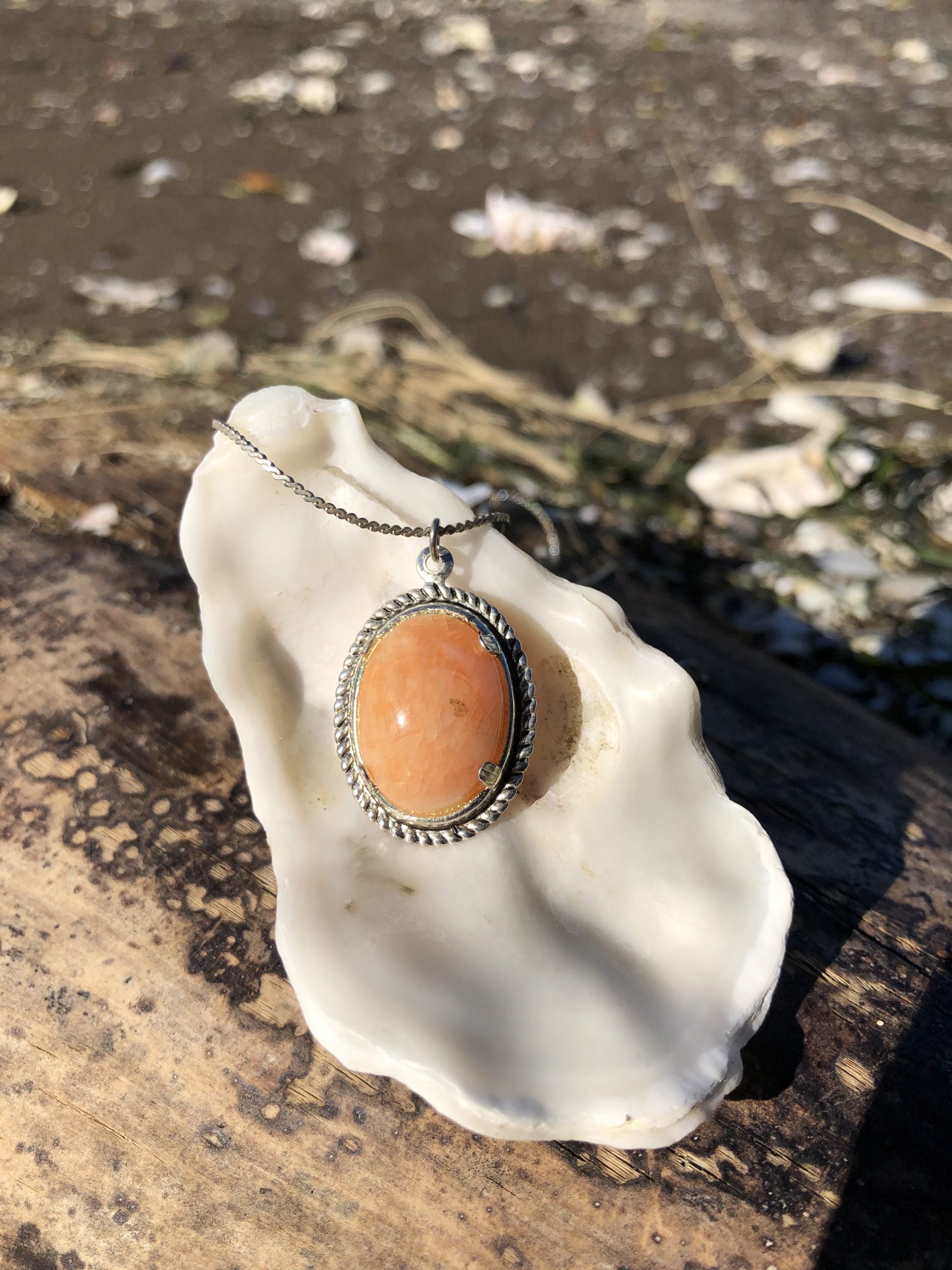 Necklace of Tangerine Agate from Agate Creek, Australia, natural tangerine orange color, hand polished to an 18x13mm cabochon and set in silver plated setting with 19 inch chain on shell