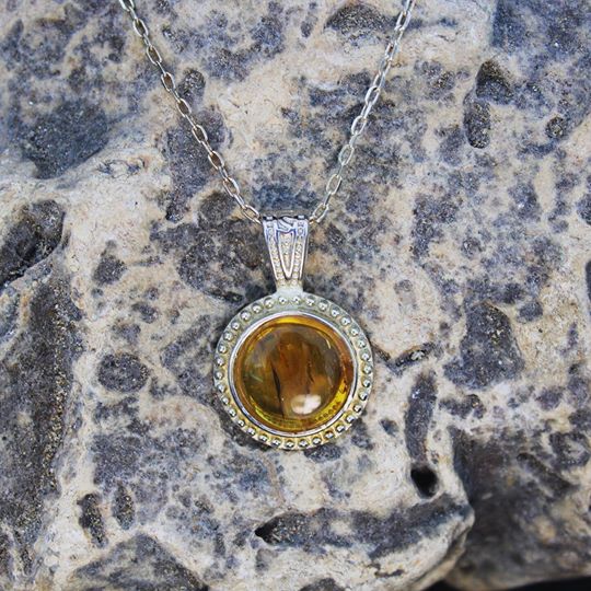 Necklace with rich, beautiful clear yellow Baltic Amber, hand polished to a 14mm round cabochon and set in a silver plated setting with 19 inch chain, on stone