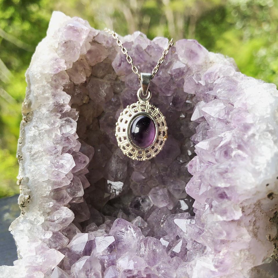 Necklace with rich, dark purple Amethyst, hand polished to a 10x8mm oval cabochon and set in a silver plated setting with 19 inch chain on geode