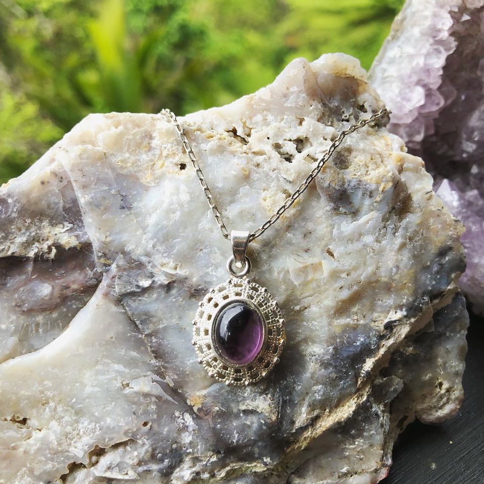 Necklace with rich, dark purple Amethyst, hand polished to a 10x8mm oval cabochon and set in a silver plated setting with 19 inch chain on rock