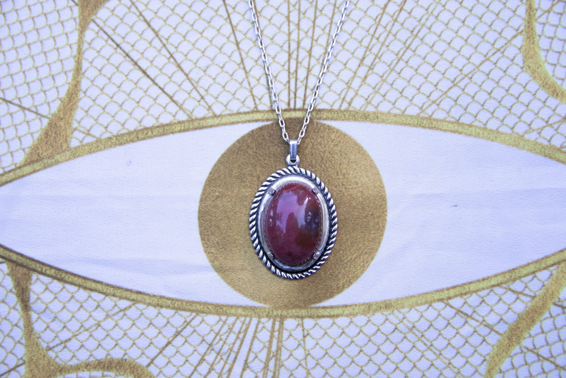 Necklace of rich red jasper from Coromandel New Zealand, hand polished into a 25x18mm cabochon and set in silver-plated setting with 19 inch chain, front