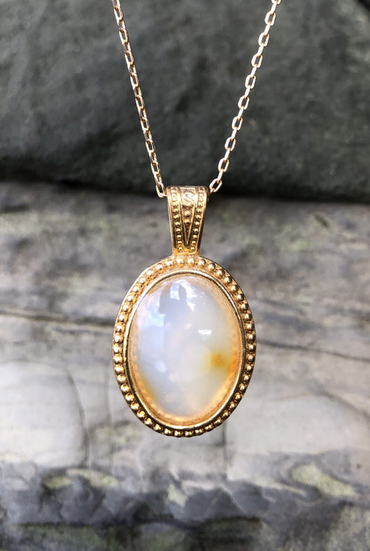 Necklace with a pale yellow with hints of orange New Zealand Carnelian, hand polished to a 25x18mm cabochon and set in a gold-plated setting with 19 inch chain, main