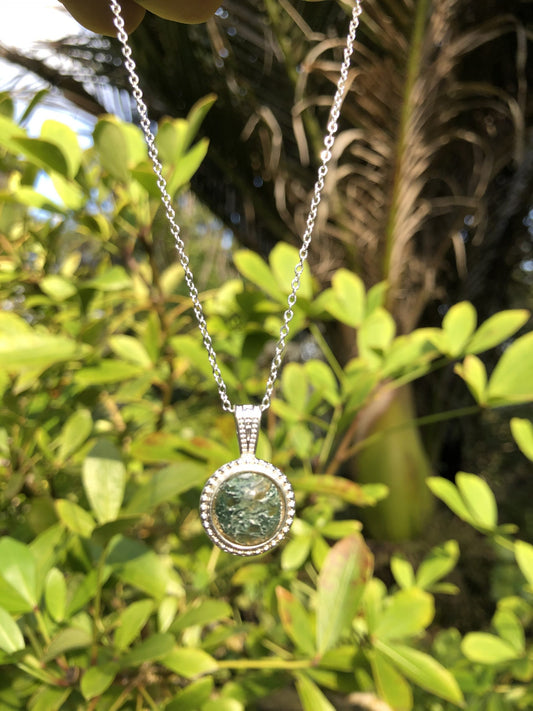 Necklace with natural Moss Agate from India, showing finely grained dark green "moss" in a transluscent agate background, hand polished to a 10mm round cabochon and set in silver-plated setting with 19 inch chain.