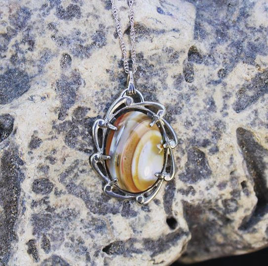 Necklace of Mt Somers Agate from Canterbury New Zealand with yellow, white and orange, hand cut to a 25x18mm cabochon and set in Sterling silver setting with 20 inch Sterling silver chain.